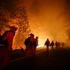 Inmate firefighters walk along Highway 120 after a burnout operation as firefighters continue to battle the Rim Fire near Yosemite National Park, Calif.